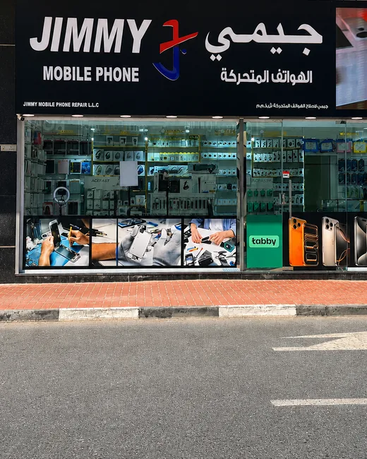 The Jimmy Mobile Phone Repair shopfront in Al Barsha 1, Dubai — window display of phones and accessories under the JIMMY sign