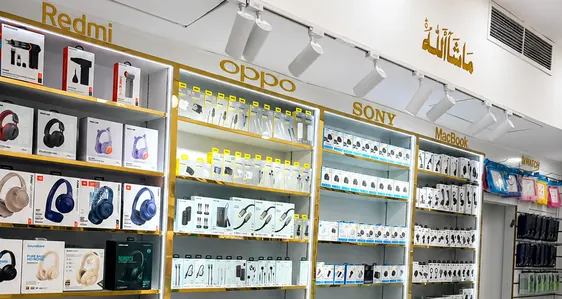 Chargers, cables and audio on the branded shelf run inside the Jimmy shop in Al Barsha 1
